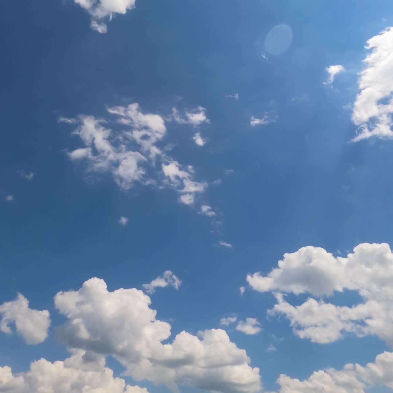 Cloudscape formation at daytime. Beautiful light cotton clouds changing shape in the blue sky. Timelapse