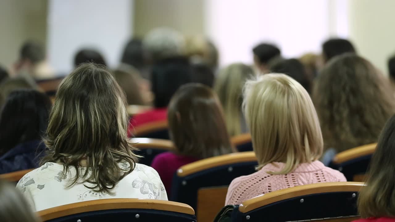 Students Listening The Lecture. VINNITSA, UKRAINE, APRIL 2017: Students listening the professor lecture, sitting rear in conference room. Education concept
