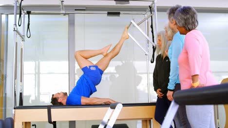 Trainer-performing-yoga-4k