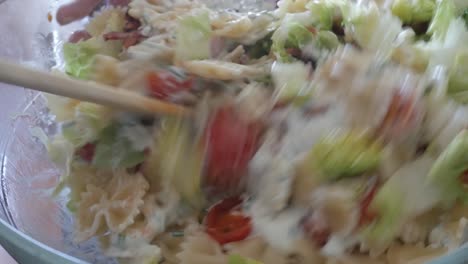 creamy pasta salad with fresh lettuce, cherry tomatoes, and bowtie pasta in a bowl