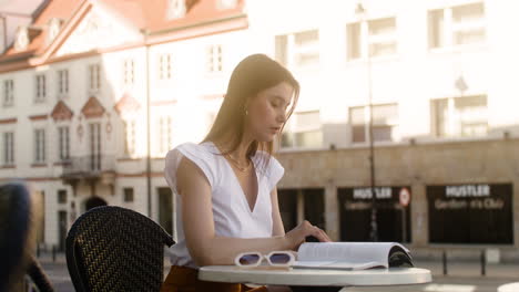 Young-fashionable-woman-sitting-outdoors