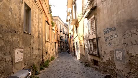 a narrow alley with a parked motorbike