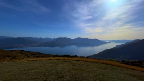 panoramic panning scene of lake maggiore seen from monte carza mountaintop viewpoint, zoom in