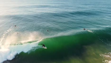 drone aerial shot of surfer riding ocean wave sand bar beach break north entrance central coast tourism nsw australia 4k