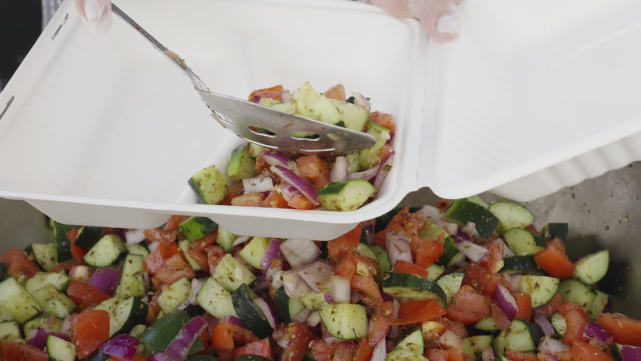 Serving Fresh Diced Vegetable Salad into a Takeout Container