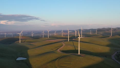 wind turbines spinning on hillside