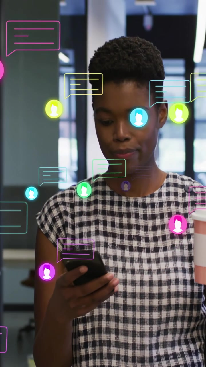 Vertical video: Business woman with cup tapping phone causing chat icons and checking work messages