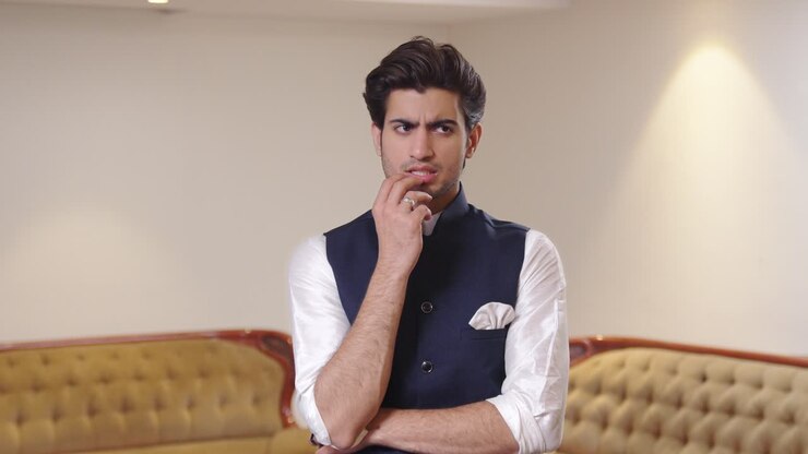 Indian man trying to think of something