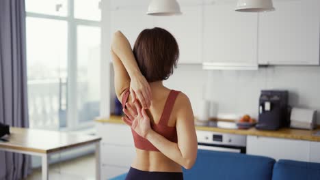 A-slender-woman-connecting-hands-behind-her-back-in-Gomukhasana