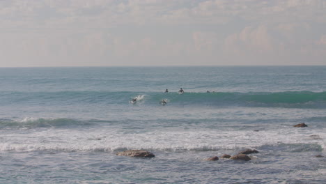 two surfers manager to catch a wave in slow motion in malibu on the west coast usa