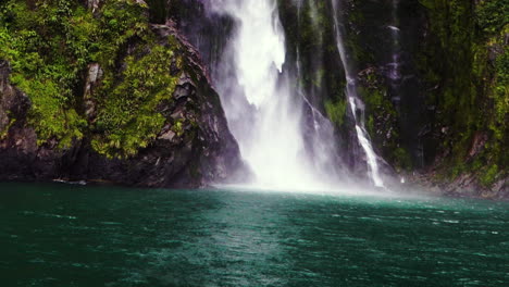 magnificent stirling falls in milford sound fjord, new zealand, from cruise boat