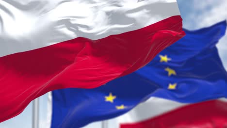 seamless loop of the national flag of poland waving in the wind with blurred european union flag in the background