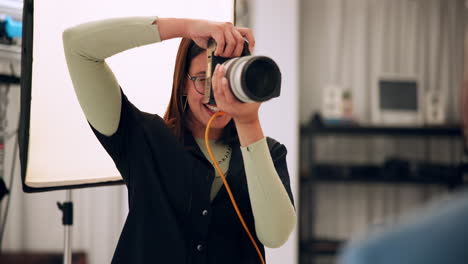 photographer in studio taking pictures