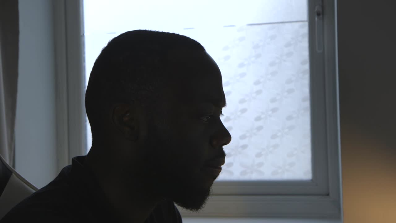 Close Up Of Black Male Listening To Music And Doing Work In Room
