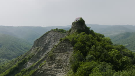 unworldly scenery of a church on a hilltop, surrounded with misty wilderness