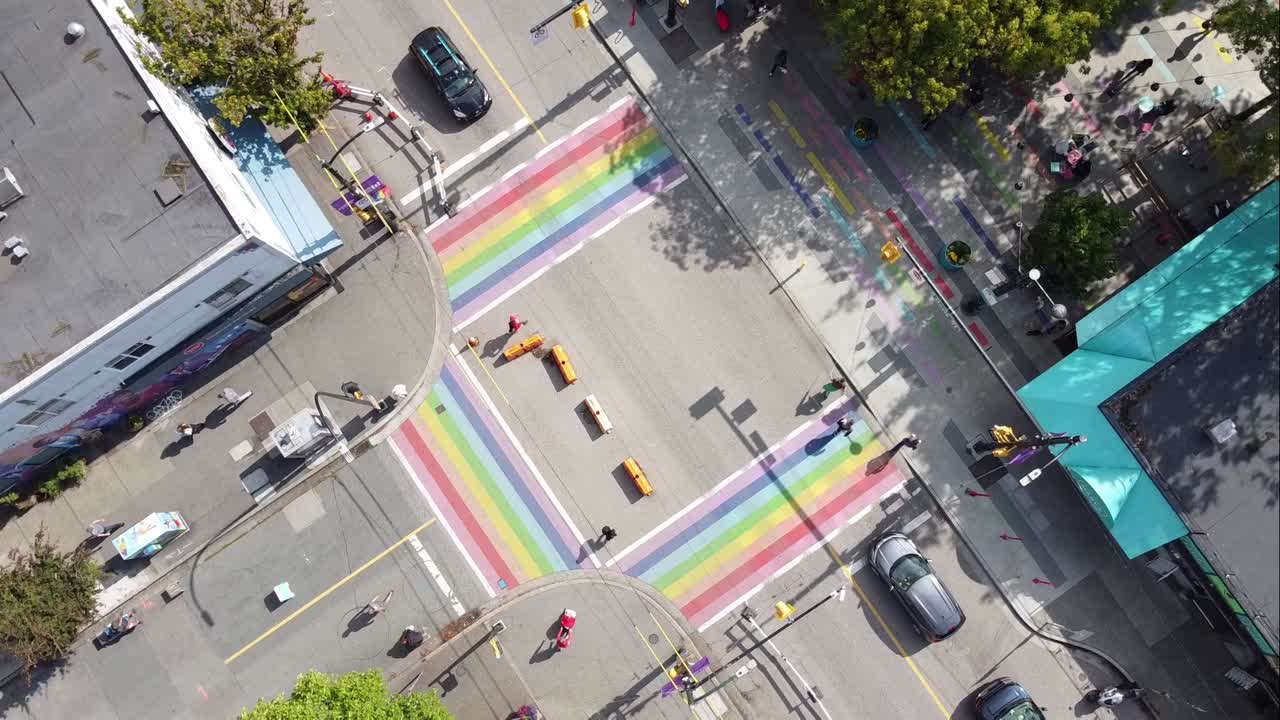 2-3 aerial twist panaramic birds eye view above Davie and Bute rainbow sidewalks in downtown Vancouver's Gay Village Coimmunity on sunny afternoon with COVID-19 barriers on streets with light traffic