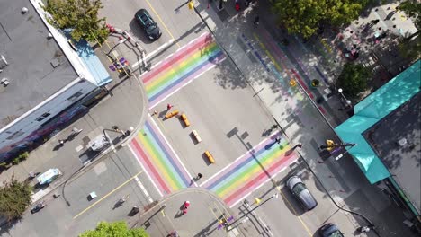 2-3 aerial twist panaramic birds eye view above davie and bute rainbow sidewalks in downtown vancouver's gay village coimmunity on sunny afternoon with covid-19 barriers on streets with light traffic