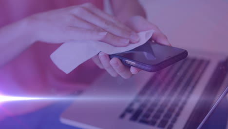 video of caucasian woman wiping her smartphone with purple tint