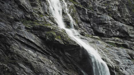 Slow-motion-shot-of-beautiful-waterfall-from-melting-of-the-Kjenndalsbreen-Glacier-in-Jostedalsbreen-National-Park,-Norway-at-daytime
