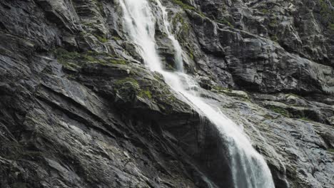 slow motion shot of beautiful waterfall from melting of the kjenndalsbreen glacier in jostedalsbreen national park, norway at daytime