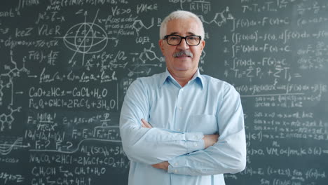 teacher in front of a chalkboard filled with equations