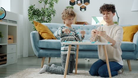 mother and son building together
