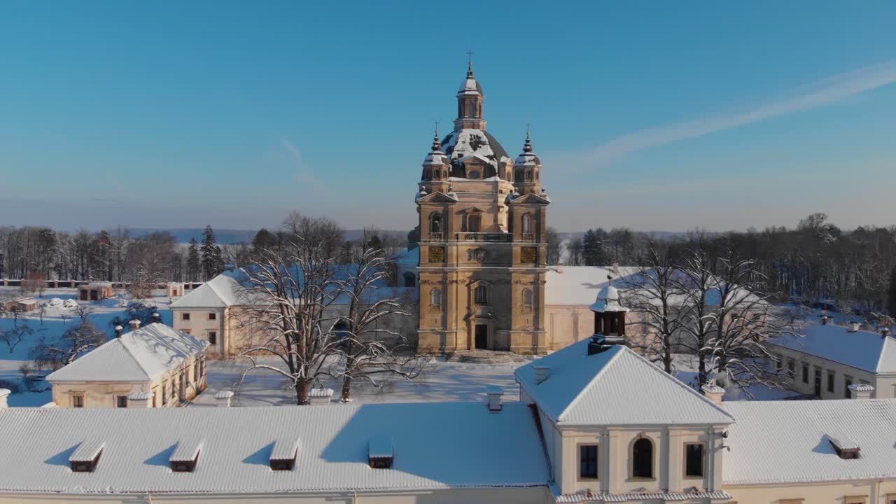 Aerial view of the Pazaislis monastery and the Church of the Visitation in Kaunas, Lithuania in winter, snowy landscape, Italian Baroque architecture, ascending