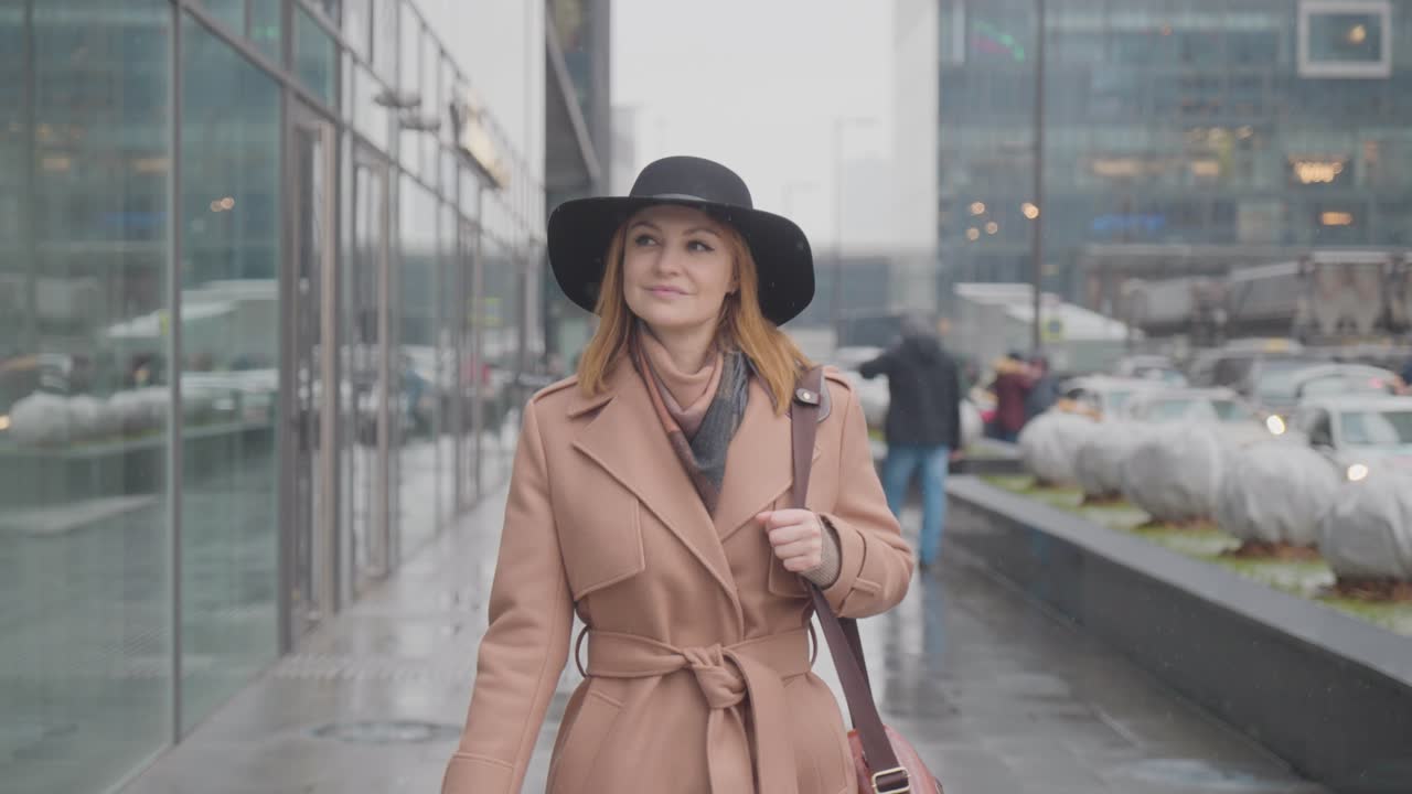 Donna che cammina in città in una giornata di pioggia