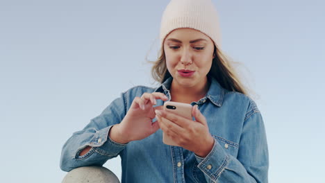 a-cheerful-young-woman-chewing-gum-while-using