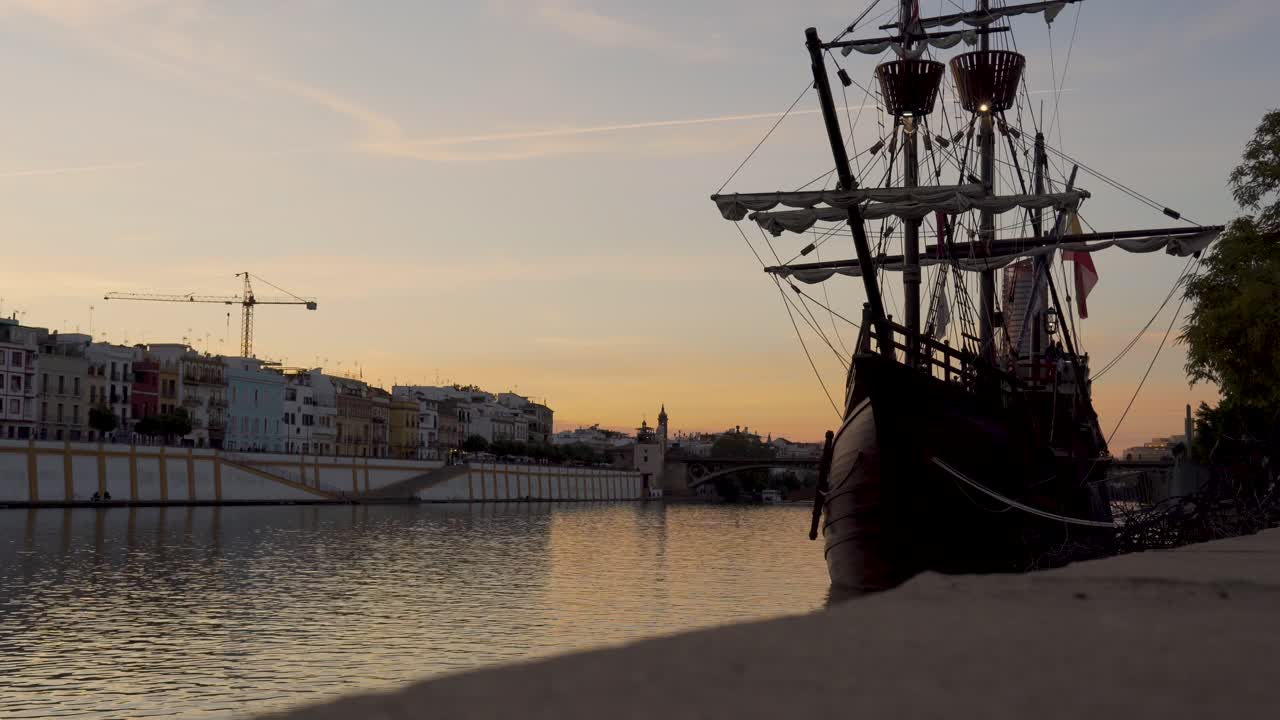 sailing ship made of wood, pirate ship of the middle ages next to a river in a beautiful Spanish city