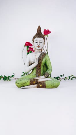 buddha statue with roses