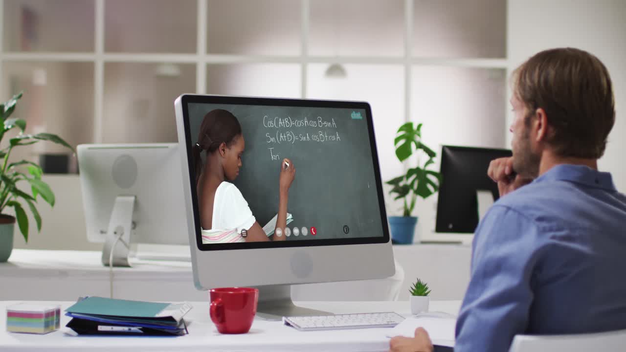 Caucasian male student using computer on video call with female teacher