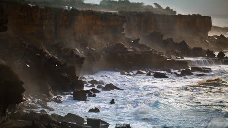 Stormy-sea-washing-rocky-coastline-on-dull-day.-Foaming-waves-hitting-wild-shore