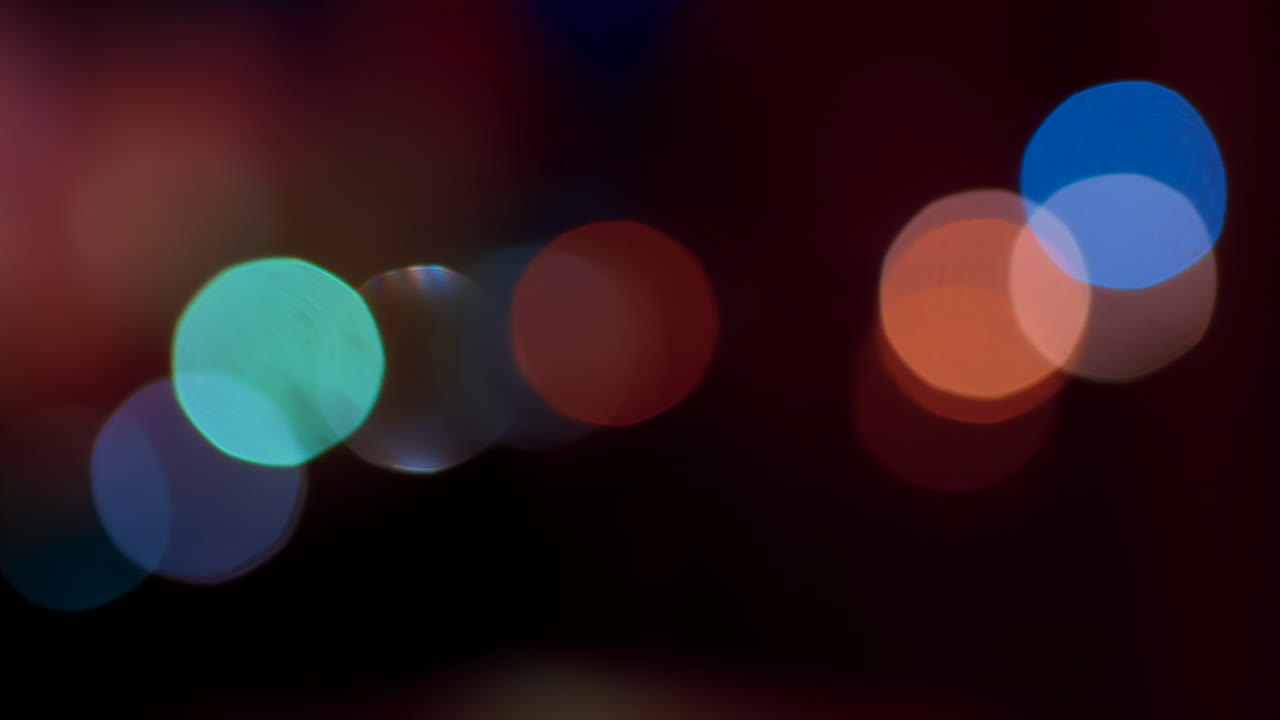 Abstract display of out-of-focus, colourful lights in a dark setting