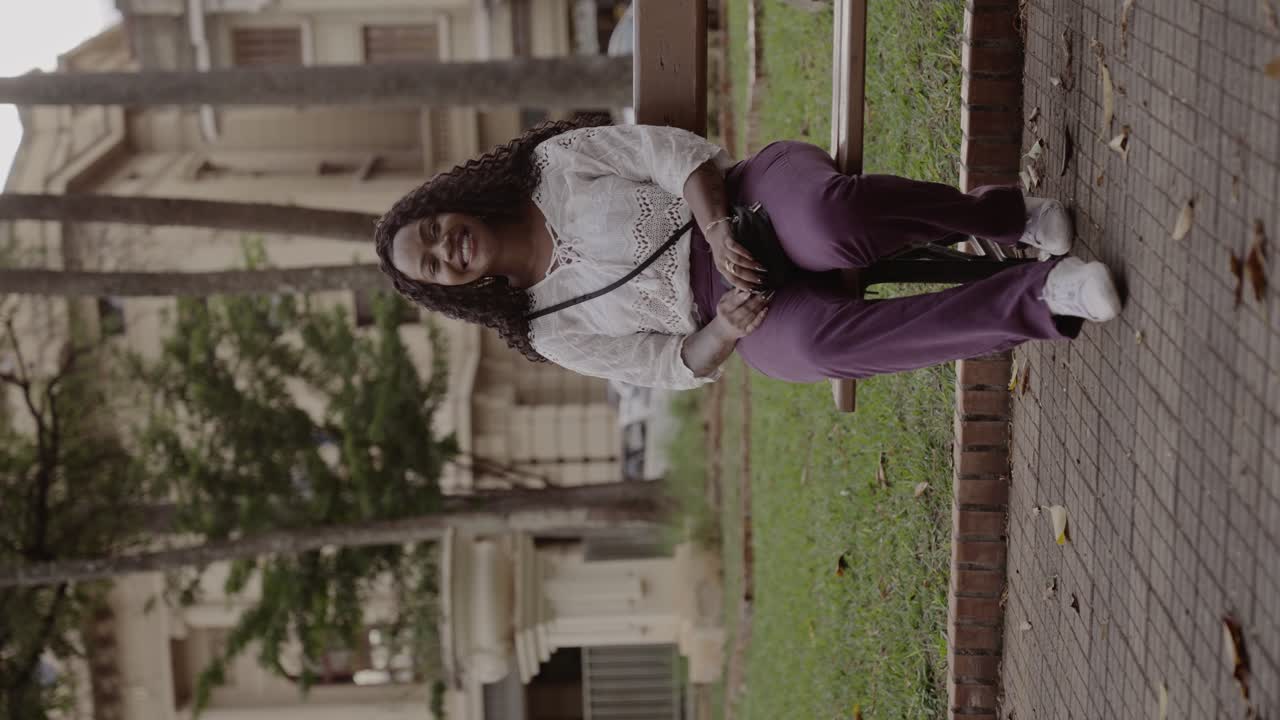 Smiling Woman Relaxing on a Park Bench