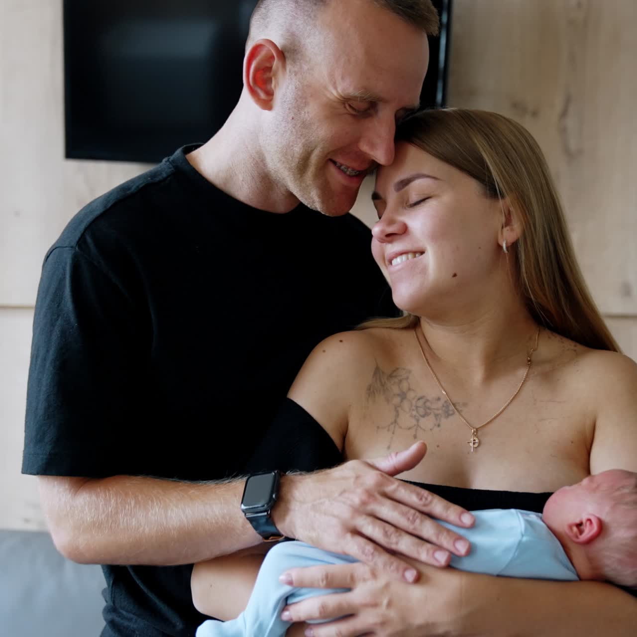 Happy Caucasian couple with a newborn in the hospital. Couple in the maternity ward after childbirth