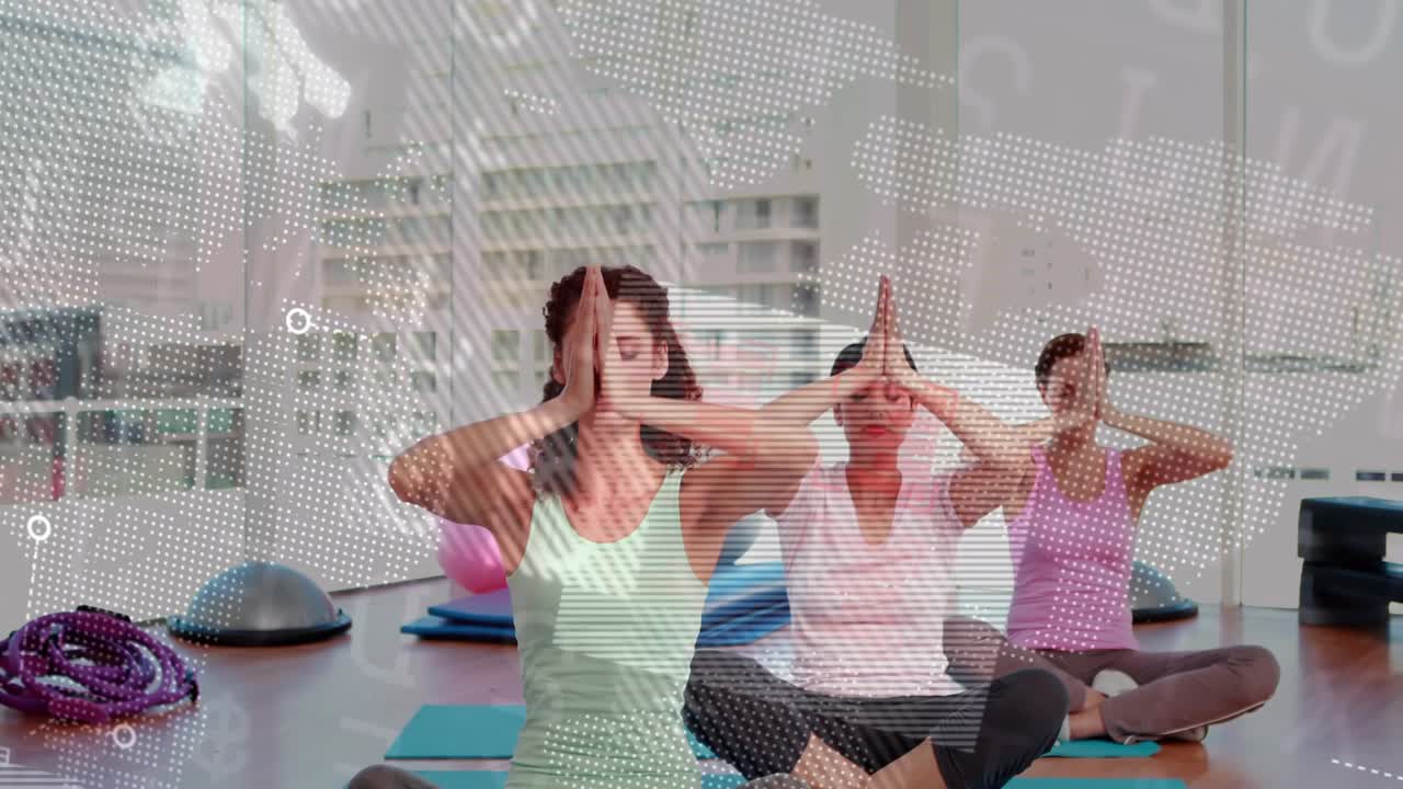 Instructor leading three women raising then lowering palms in yoga studio, map overlay aiding focus