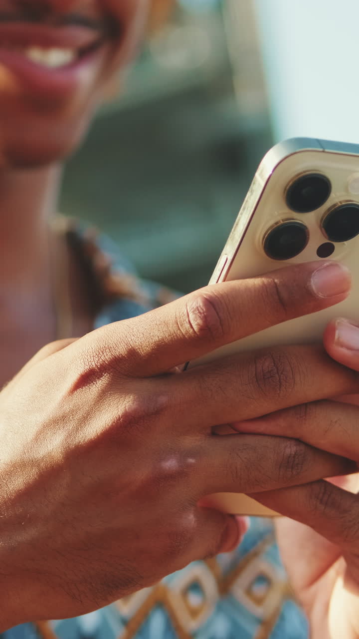 Close-up of Young Man's Hands Using Smartphone Outdoors