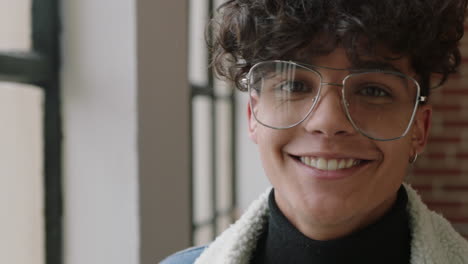 close-up-portrait-stylish-young-hispanic-man-student-smiling-happy-enjoying-successful-lifestyle-wearing-trendy-fashion-glasses-looking-out-window-in-modern-apartment-loft