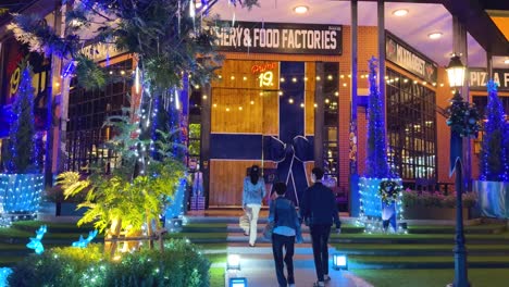 couple walking towards a decorated restaurant entrance