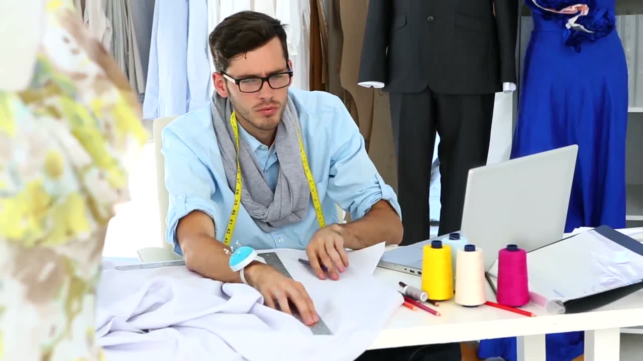 Stilista che misura un pezzo di tessuto