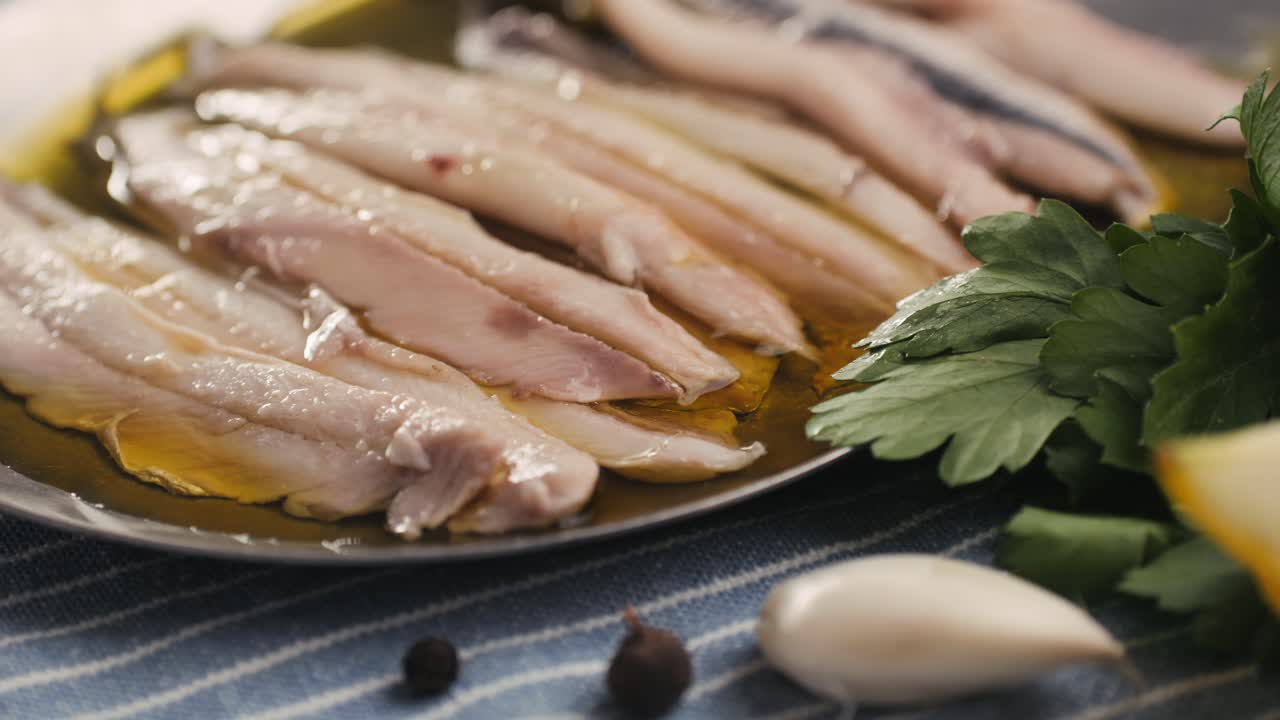 Fresh Sea sardines and Anchovy Fish and Mullus On Display On Ice On Market Store Shop. Seafood Fish Background, close up stand of small salty white fish.