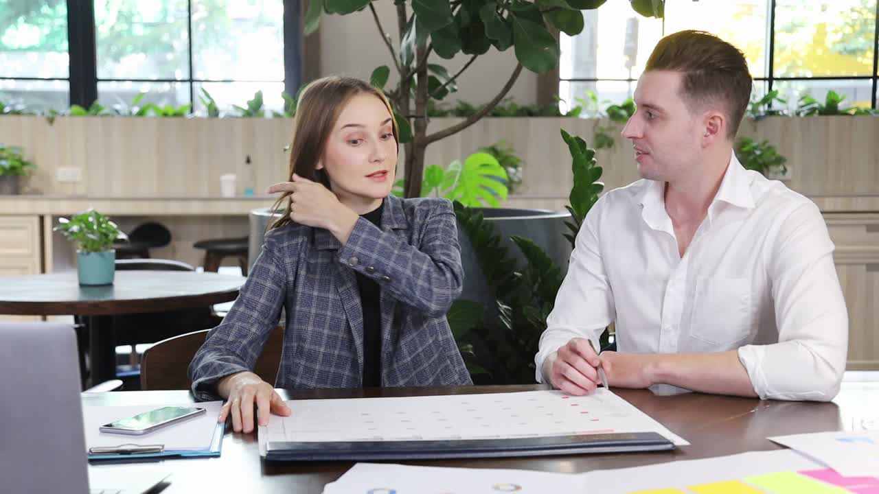 la gente de negocios caucásica está trabajando en una nueva planificación estratégica para el próximo año planificador y calendario mientras trabaja en un espacio de trabajo moderno y ecológico rodeado de una planta de purificación de aire