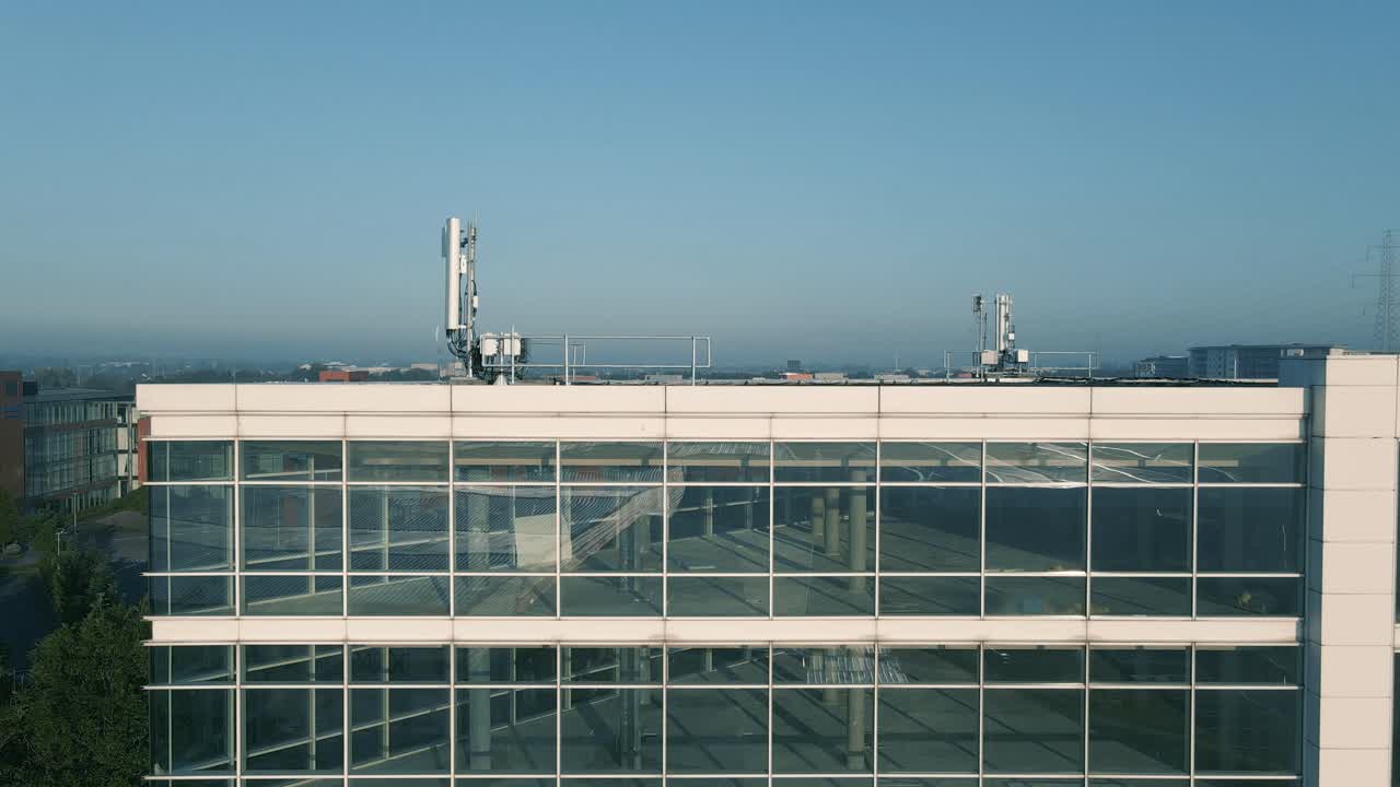 An Office Building With Transmission Antenna On The Rooftop Deserted Due To Coronavirus Crisis In Dublin, Ireland - aerial drone