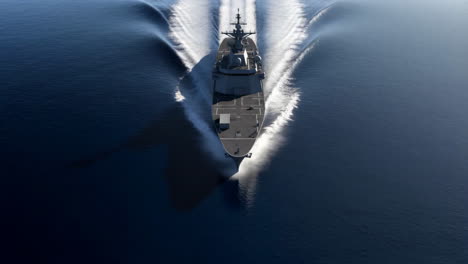overhead view of a warship moving through the water