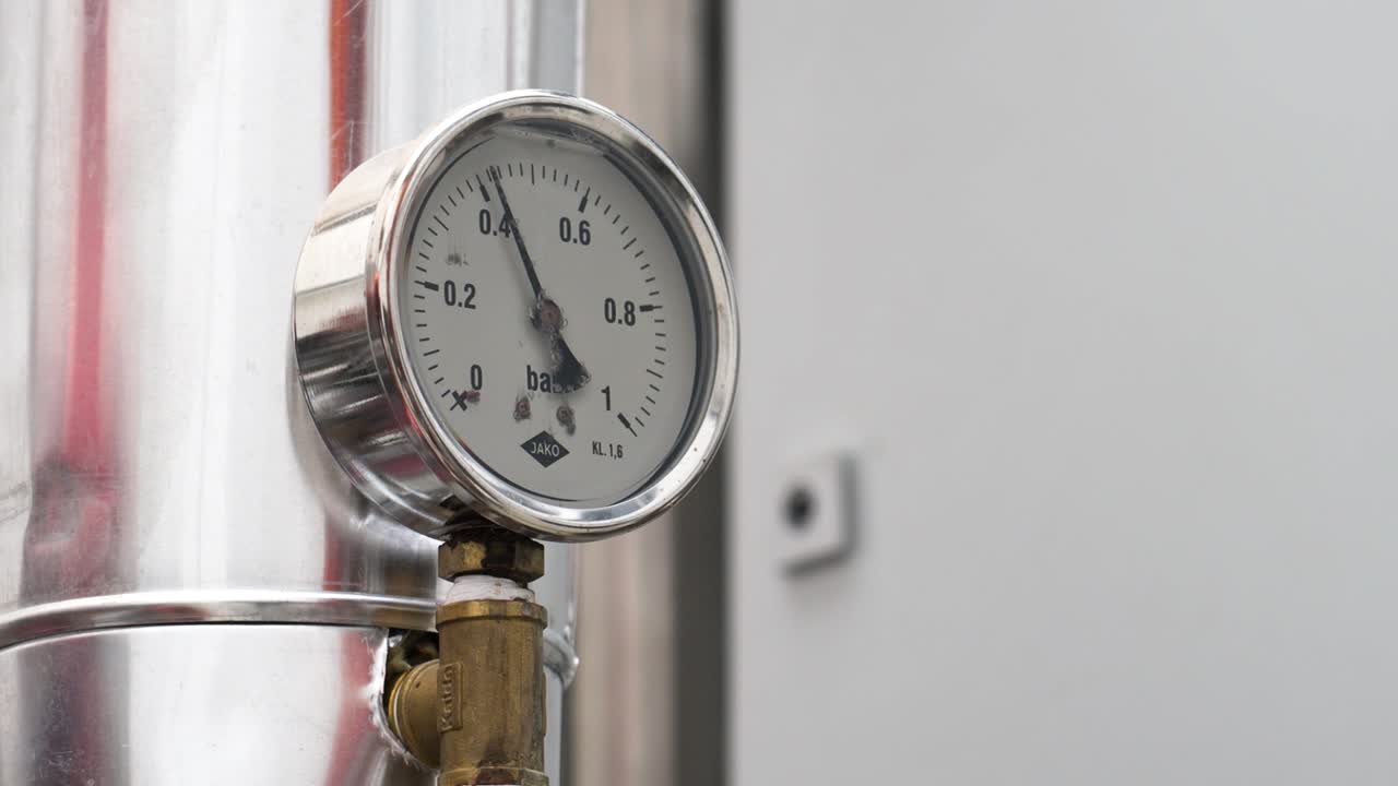 Close-up of a pressure gauge in a stainless steel environment
