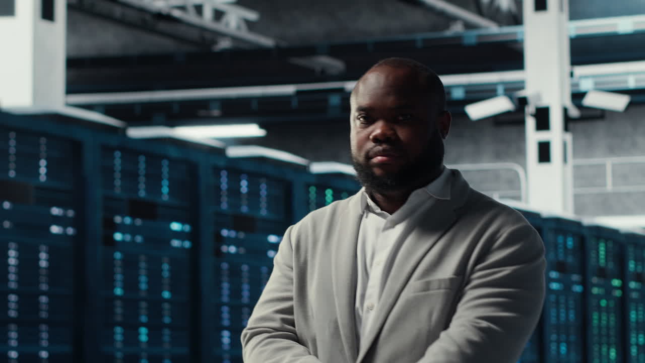 Vertical video Smiling engineer in server hub monitoring data center energy consumption