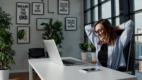 woman relaxing at her modern home office