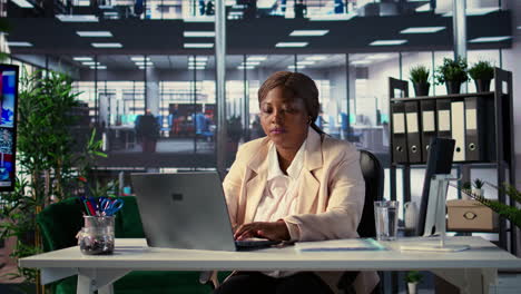 woman working on laptop in modern office