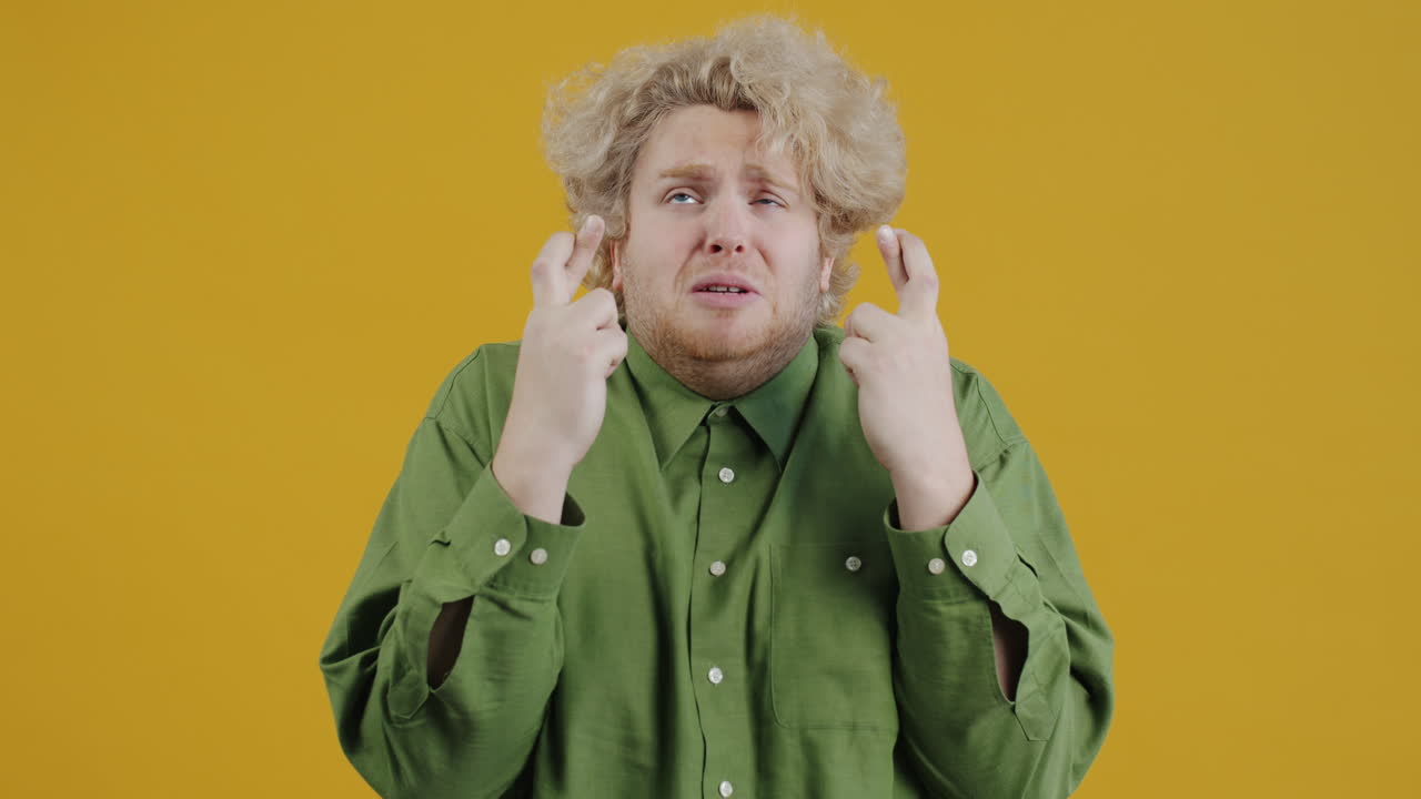 Man hoping, fingers crossed